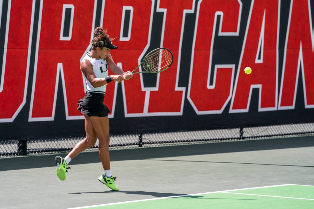 Fourth-year junior Daevenia Achong Returns the ball during the fourth game of her singles match versus Clemson junior Eleni Louka at the Neil Schiff Tennis Center on Feb.  27, 2022.