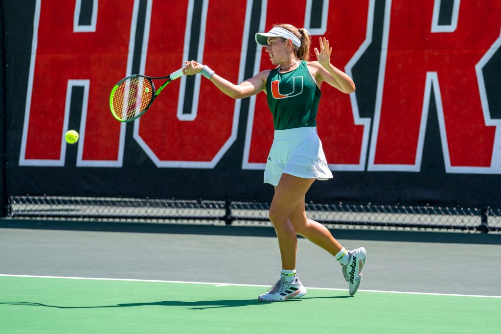 Sophomore Isabella Pfennig returns the ball during the fourth game of the first set of her singles match against Seminole freshman Olympe Lancelot at the Neil Schiff Tennis Center on March 11, 2022.