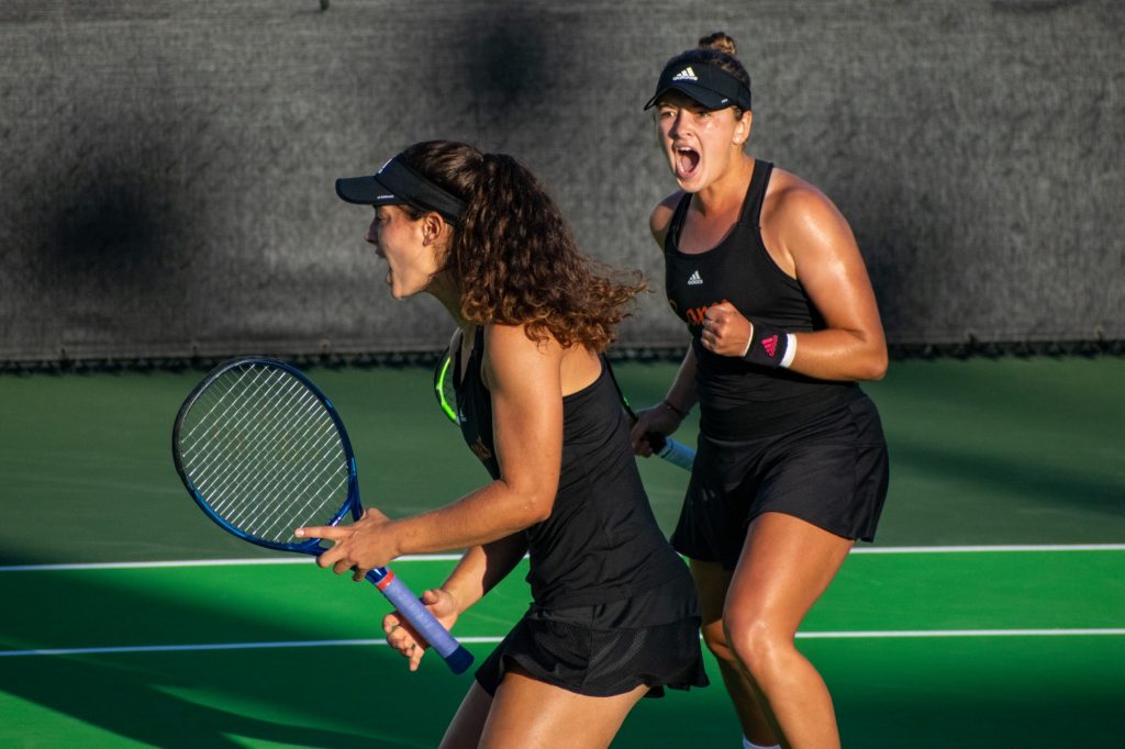 Third-year sophomores Diana Khodan and Maya Tahan celebrate a point during their doubles match against Georgia Tech at the Neil Schiff Tennis Center on Feb. 25, 2022.