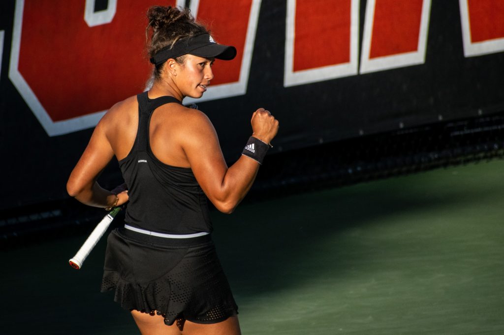 Fourth-year junior Daevenia Achong celebrates Miami's point over Kylie Bilchev and Ava Hrastar of Georgia Tech at the Neil Schiff Tennis Center on Feb.  25, 2022.