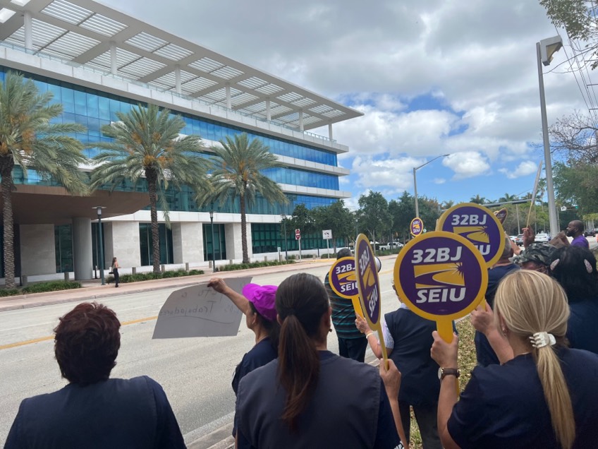 Demonstrators gathered on South Dixie Highway, across from the Lennar Center, on April 12 to protest ABM’s treatment of their workers.