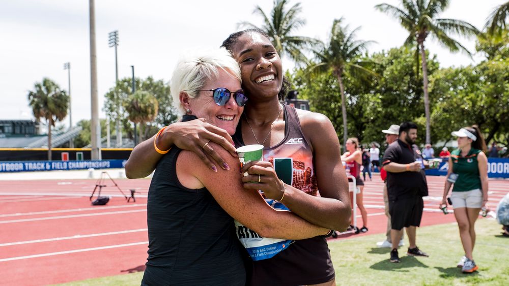 Miami track and field coach Amy Deem celebrates with former six-time All-American Michelle Atherley at the ACC Outdoor Track & Field Championships at Cobb Stadium.