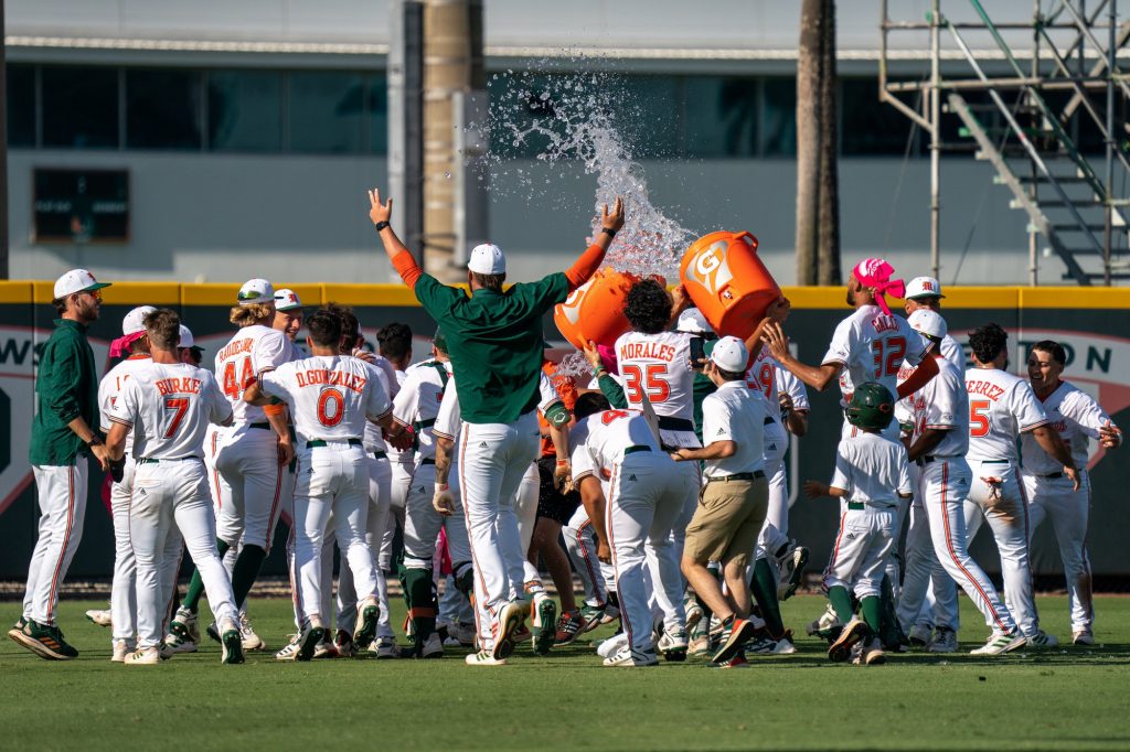 Canes baseball players celebrate after freshman outfield/infielder Renzo Gonzalez’s walk off single RBI, earning the Canes a 3-2 victory over the Tarheels, in the bottom of the 14th inning of Miami’s game versus the University of North Carolina at Chapel Hill at Mark Light Field on March 27, 2022.