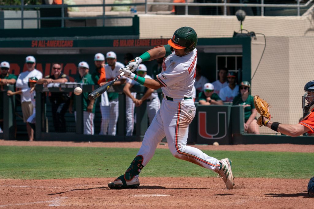 Junior catcher Maxwell Romero Jr. hits a single to right field in the bottom of the fourth inning of Miami’s game versus the University of Virginia at Mark Light Field on April 10, 2022.