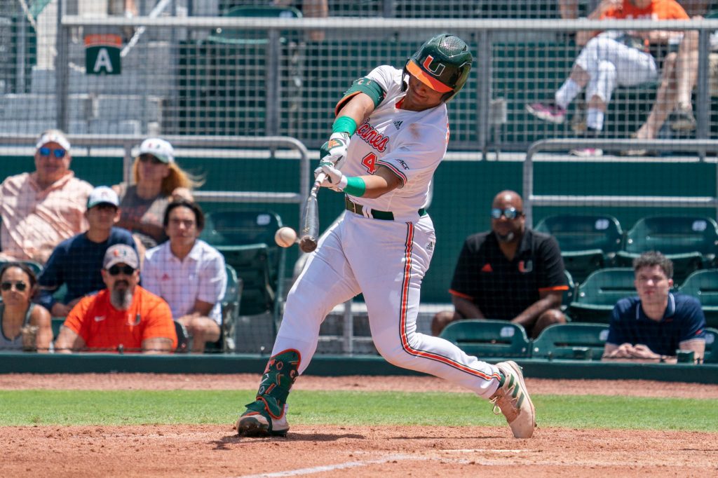 Junior catcher Maxwell Romero Jr. hits a single to right center field in the bottom of the third inning of Miami’s game versus the University of Virginia at Mark Light Field on April 10, 2022.