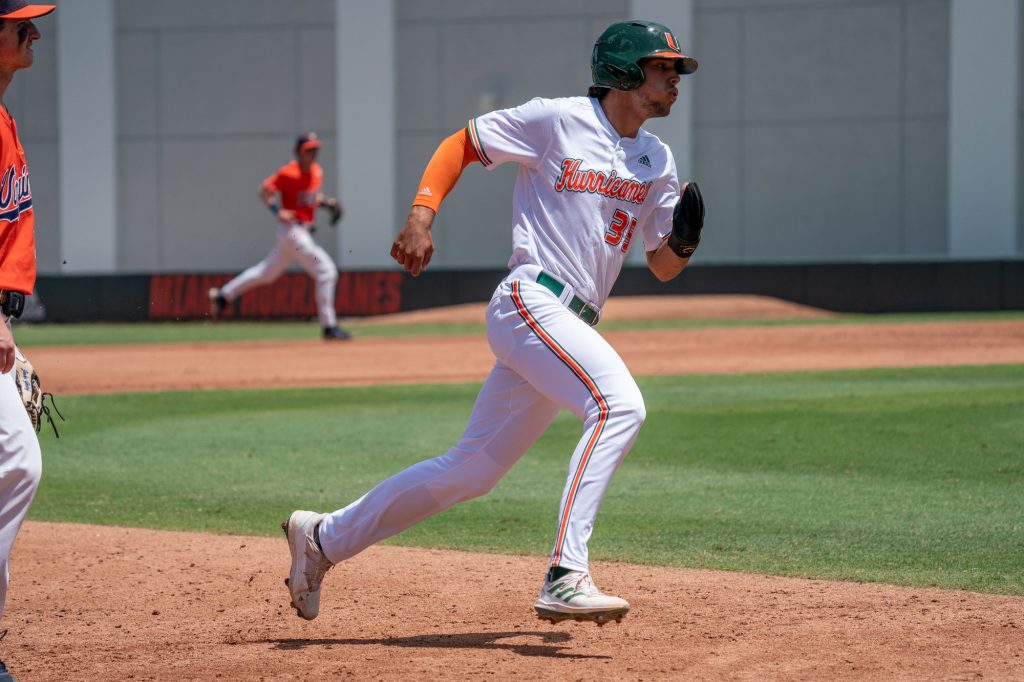 Sophomore infielder Yohandy Morales advances to third base on junior catcher Maxwell Romero Jr.’s single to right center field in the bottom of the third inning of Miami’s game versus the University of Virginia at Mark Light Field on April 10, 2022.