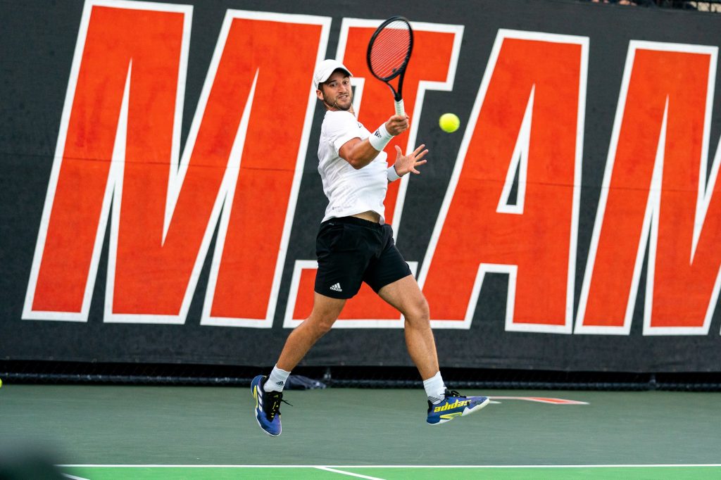 Graduate student Dan Martin returns the ball during the seventh game of the first set of his singles match versus senior Brian Cernoch at the Neil Schiff Tennis Center on March 11, 2022.
