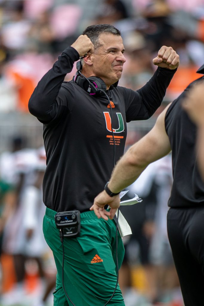 Head coach Mario Cristobal flexes for cheering fans during Miami's Spring Game at DRV PNK Stadium on April 16, 2022.