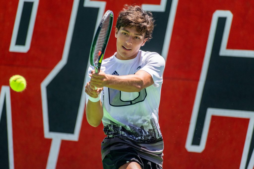 Fourth-year junior Franco Aubone rallies a ball during his doubles match with partner Juan Martin Jalif against Rodesch and Botzer of Virginia on Sunday April 10, 2022 at the Neil Schiff Tennis Center.