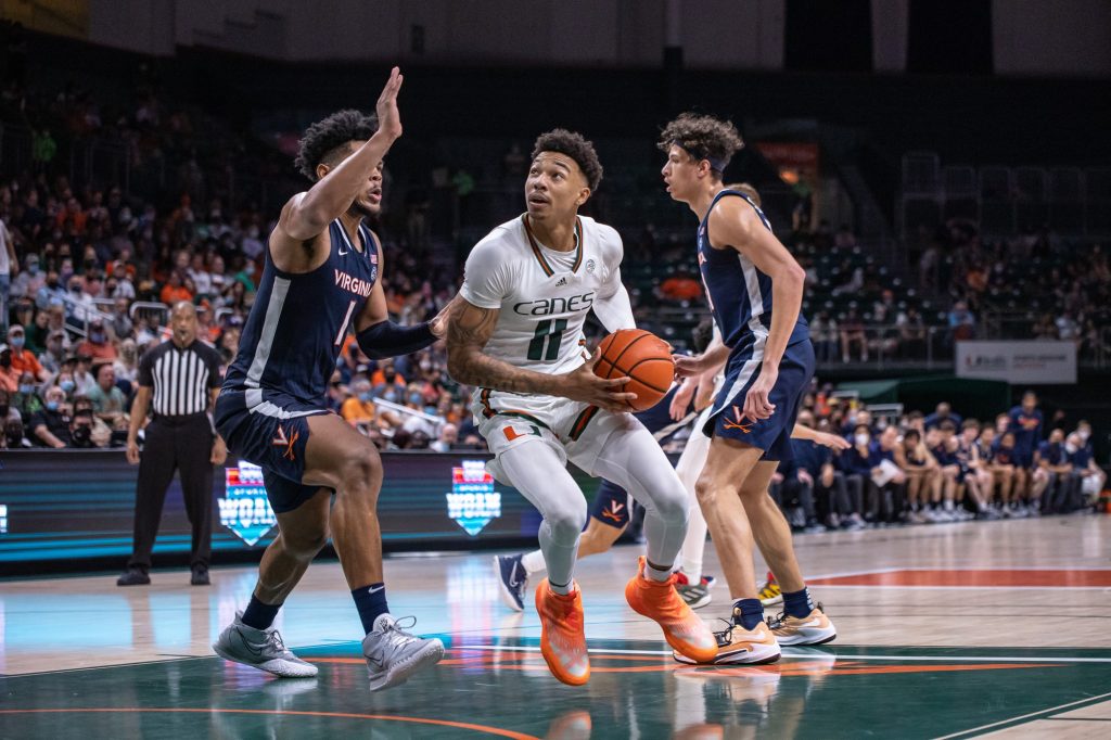 Fourth-year junior Jordan Miller works past a defender in Miami's loss to Virginia at the Watsco Center on Saturday, Feb. 19. Miller scored 15 points shooting 7-11 from the field.