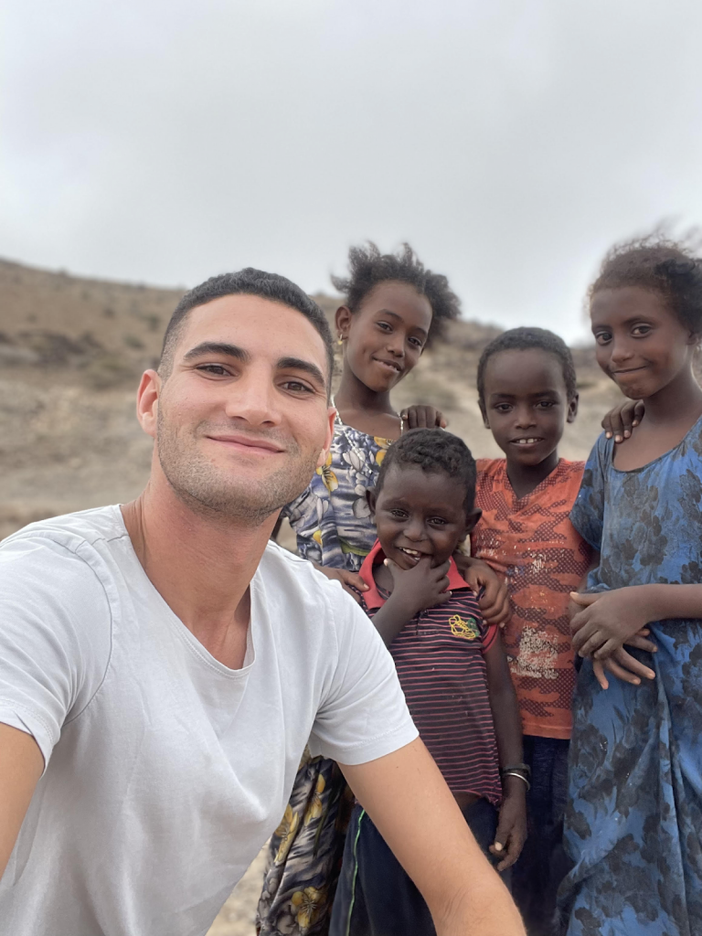 Mofid poses with children from the Afar enthic group while traveling in Djibouti in April.