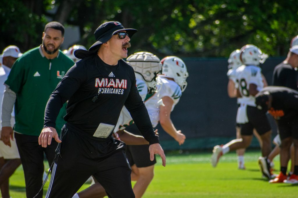 Head strength coach Aaron Feld yells at players at Miami’s spring practice on March 9, 2022 at the Greentree practice fields.