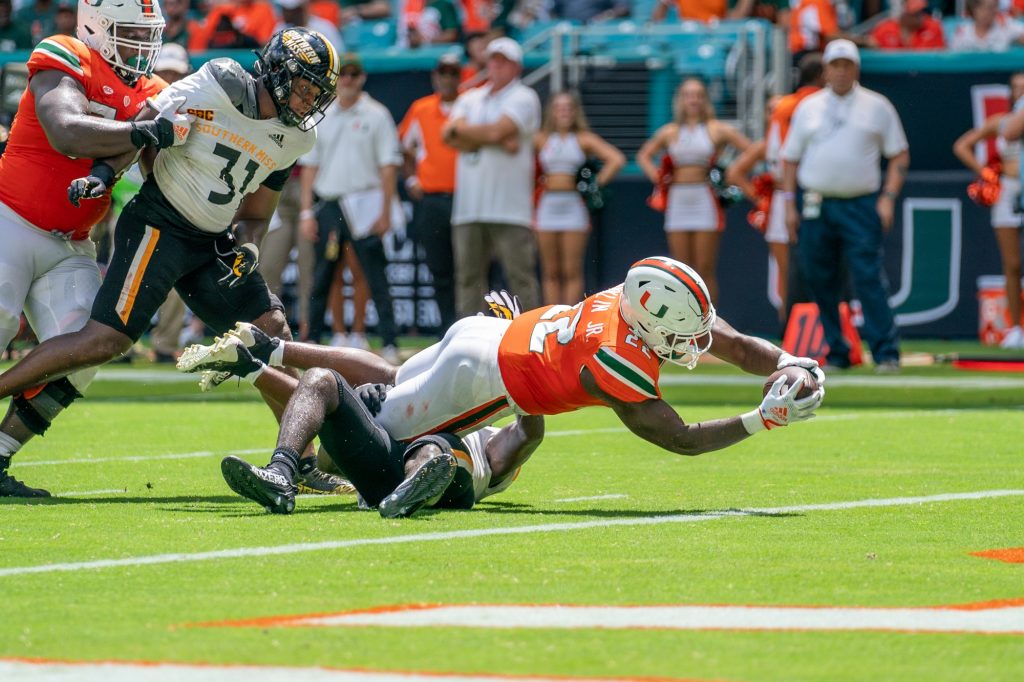Sophomore running back Thaddius Franklin, Jr. dives into the end zone for a touchdown during the third quarter of Miami’s game versus the University of Southern Mississippi at Hard Rock Stadium on Sept. 10, 2022.
