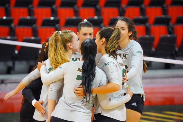 Miami volleyball players huddle during its match against St. John's in Las Vegas on Sept. 2, 2022.