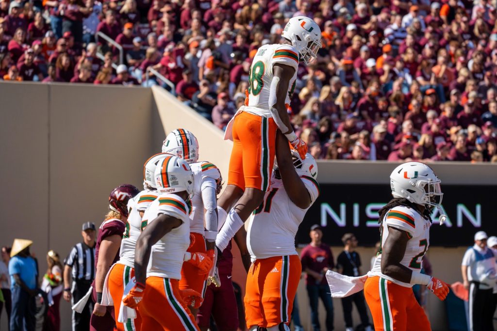The Hurricanes celebrate after wide receiver Colbie Young's 17-yard touchdown reception during Miami's game against Virginia Tech on Oct. 15 at Lane Stadium.