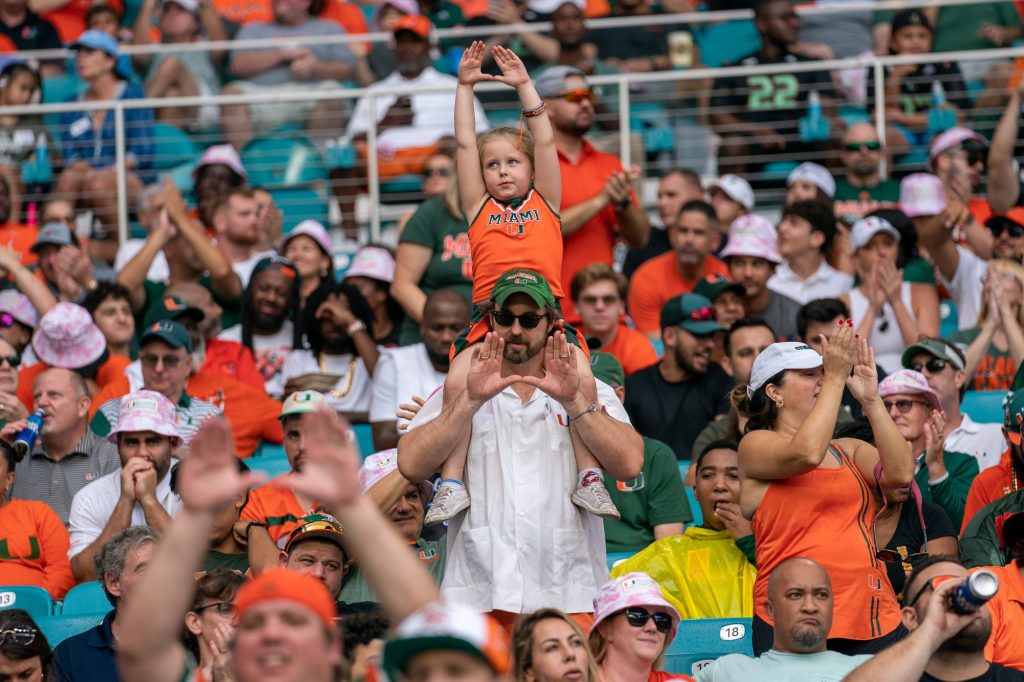 ‘Canes fans throw up the U during the first quarter of Miami’s game versus the University of North Carolina at Hard Rock Stadium on Oct. 8, 2022.