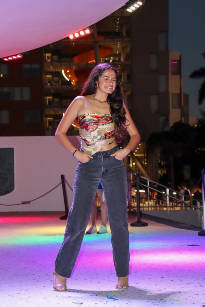 Model Gladiz Velez smiles at the end of the runway during the Uthrift Fashion Show on Oct. 26 at the Lakeside Patio Stage.