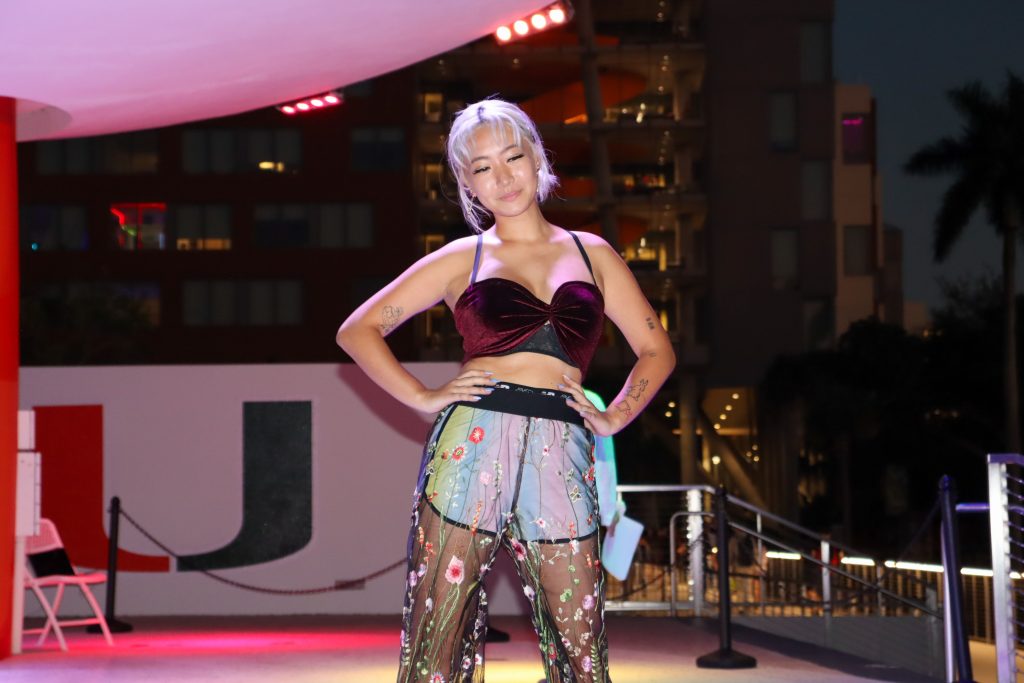 Model Jess Li poses at the end of the runway in her fully thrifted outfit at the annual Uthrift Fashion Show on Oct. 26 at the Lakeside Patio Stage