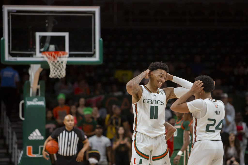 Fifth-year senior guard Jordan Miller and third-year sophomore guard Nijel Pack celebrate as the Canes dominate the Rattlers in the second half of Miami’s game at the Watsco Center on Tuesday, Nov. 15.
