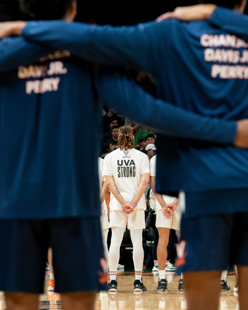 ‘Canes and Cavaliers players wear warmup shirts in remembrance of the three members of the University of Virginia’s football team killed in a shooting on Nov. 13, before Miami’s game versus the University of Virginia in the Watsco Center on Dec. 20, 2022.
