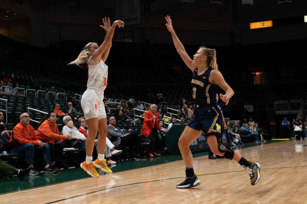 Senior guard Haley Cavinder shoots a 3-point shot during Miami’s game against Michigan on Friday, Dec.1 at the Watsco Center