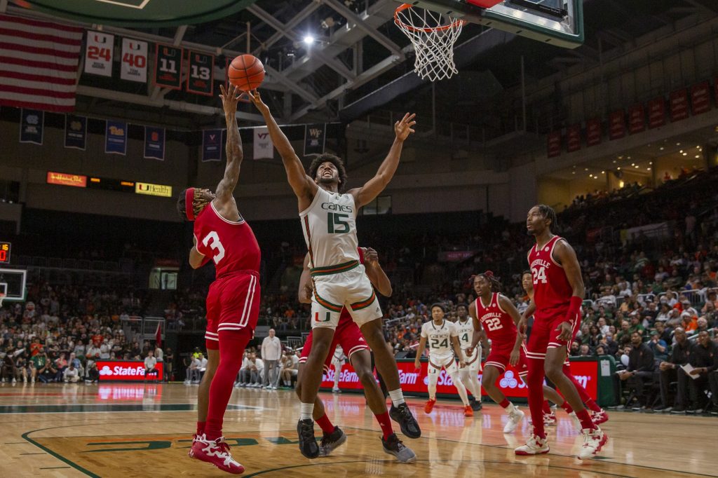 Third-year sophomore forward Norchad Omier attempts to block a Louisville shot in the second half of Miami’s win at the Watsco Center on Saturday, Feb. 11.
