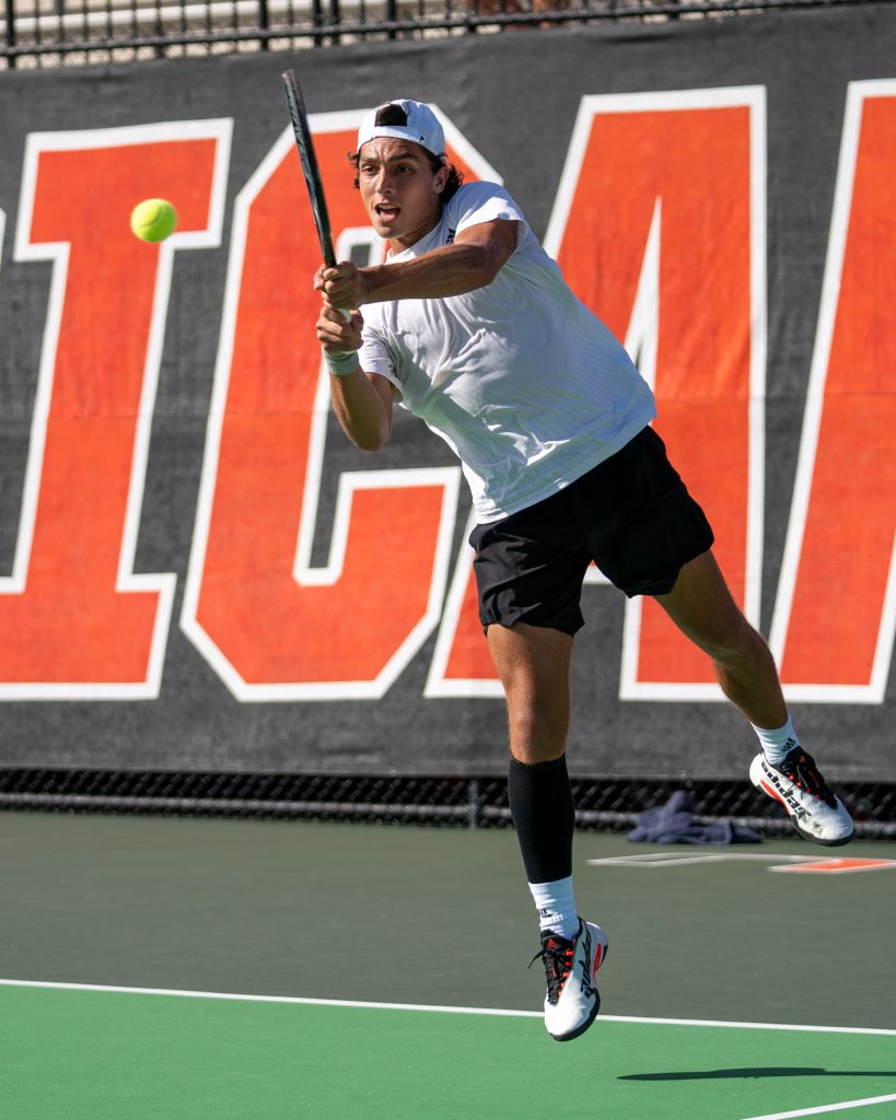 Fifth-year senior Franco Aubone returns the ball during the seventh game of his doubles match at the Neil Schiff Tennis Center on Feb. 10, 2023.