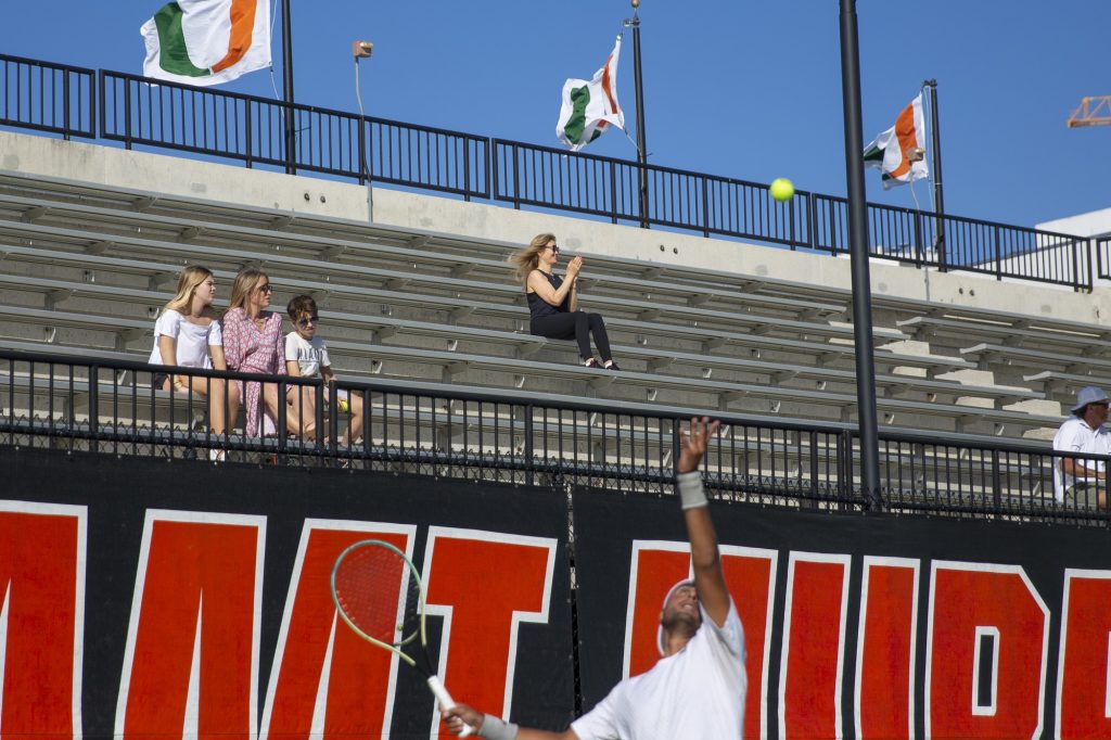 An audience member cheers on the 'Canes at the Neil Schiff Tennis Center during Miami’s matches against FNU on Friday, Feb. 10.