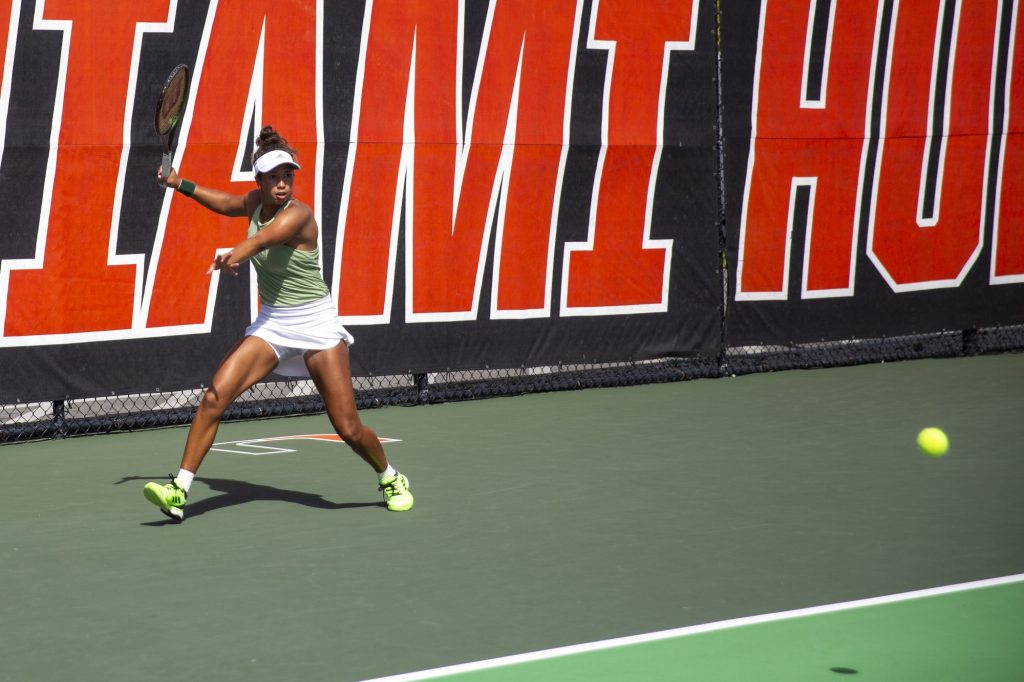 Fifth-year senior Daevenia Achong returns the ball during Miami’s singles matches against the University of California Golden Bears at the Neil Schiff Tennis Center of Saturday, Feb. 11.