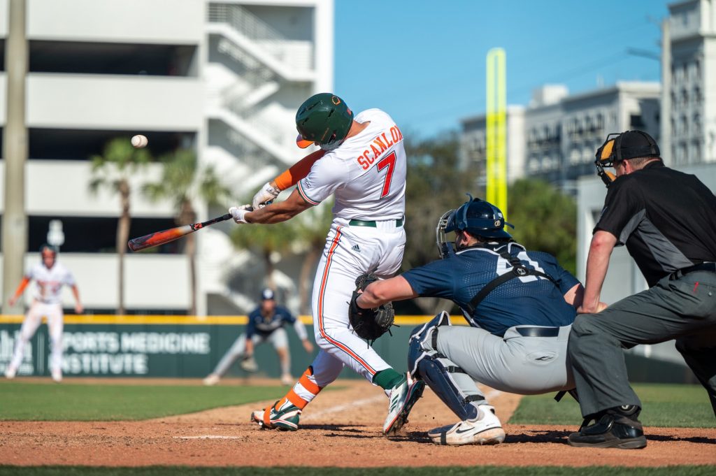 Junior catcher Jake Scanlon hits the ball during the final innings of Miami's game against Penn State University on Sunday, Feb. 19 at Mark Light Field.