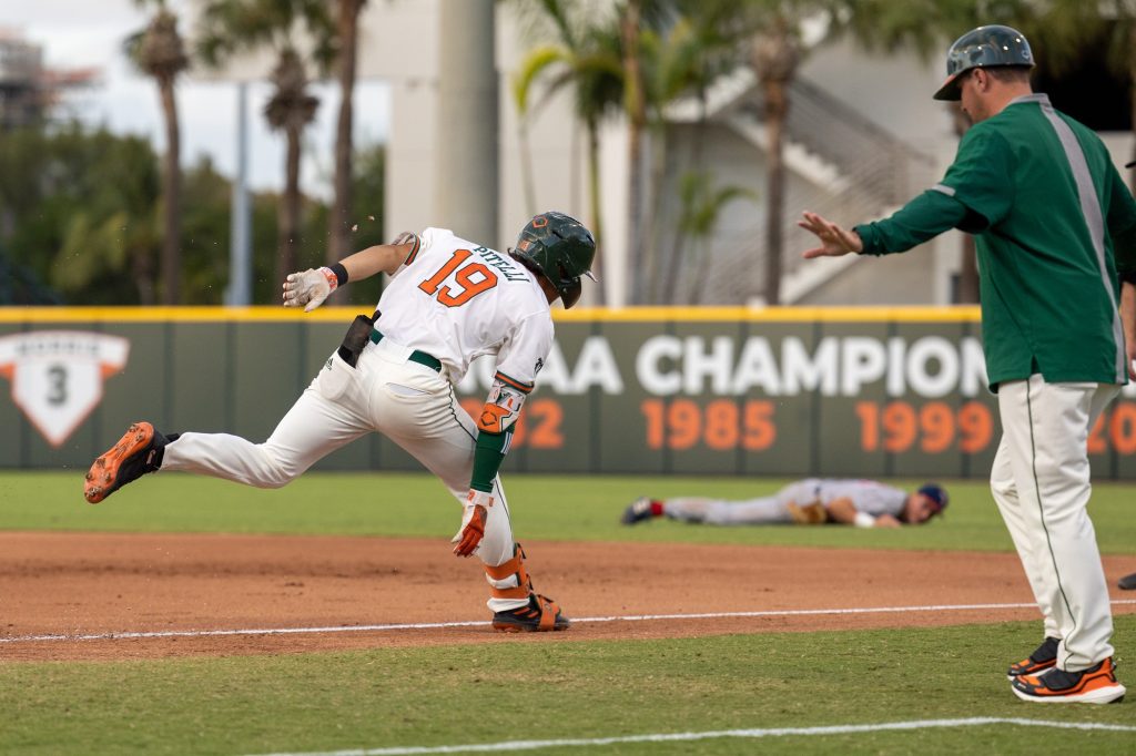 Junior Dominic Pitelli makes it through first base safe at the bottom of the fifth inning of Miami’s game against FAU at Mark Light Field on Wednesday, March 22.