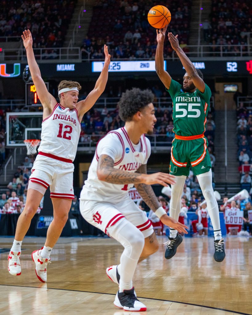 Sophomore guard Wooga Poplar shoots a three-pointer during the second half of Miami’s Round of 32 matchup against Indiana University in MVP Arena in Albany, N.Y. on March 19, 2023.