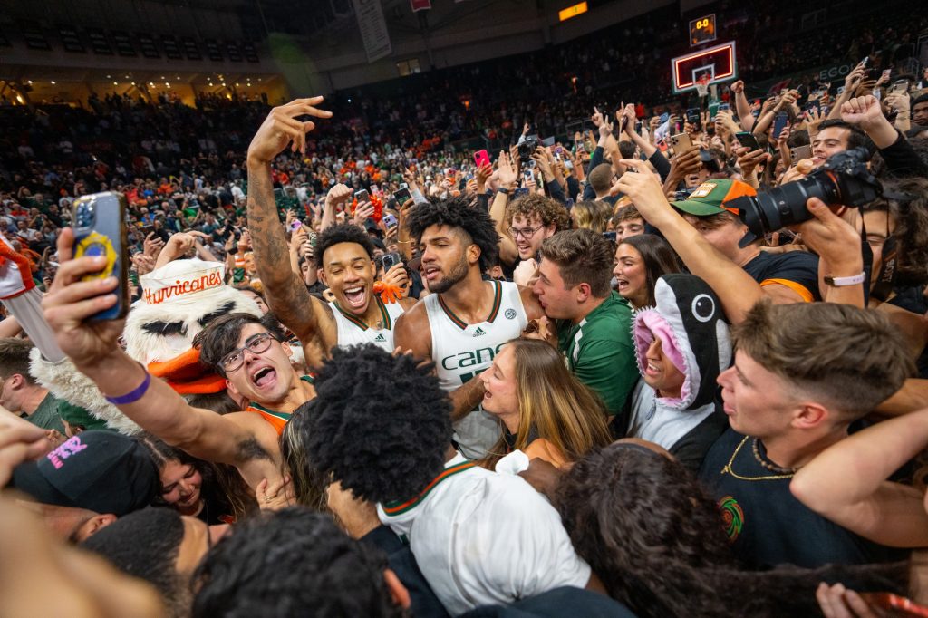 ‘Canes fans and players celebrate Miami’s 78-76 win over the University of Pittsburgh in the Watsco Center on March 4, 2023. The win earned them the program’s second-ever regular ACC championship.