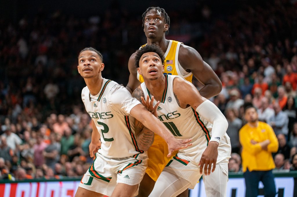 Guards Isaiah Wong and Jordan Miller look on during a free throw in the second half of Miami’s game versus the University of Pittsburgh in the Watsco Center on March 4, 2023.