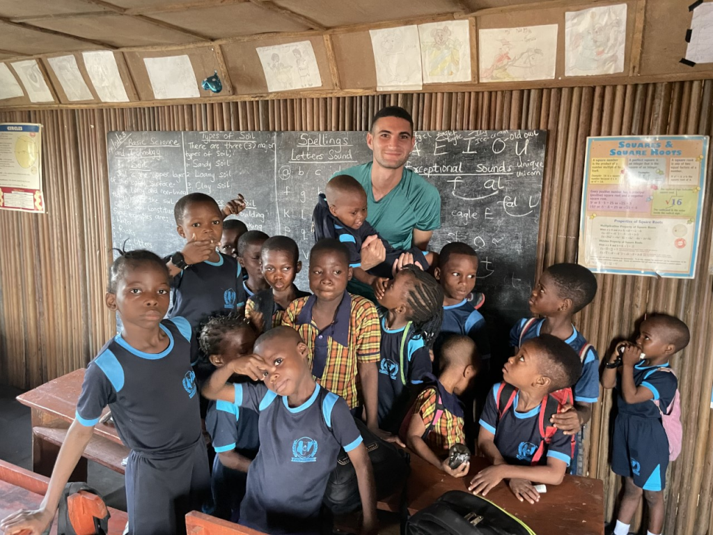 Cameron with students at the Part of Solution Nursery and Primary School in Lagos, Nigeria