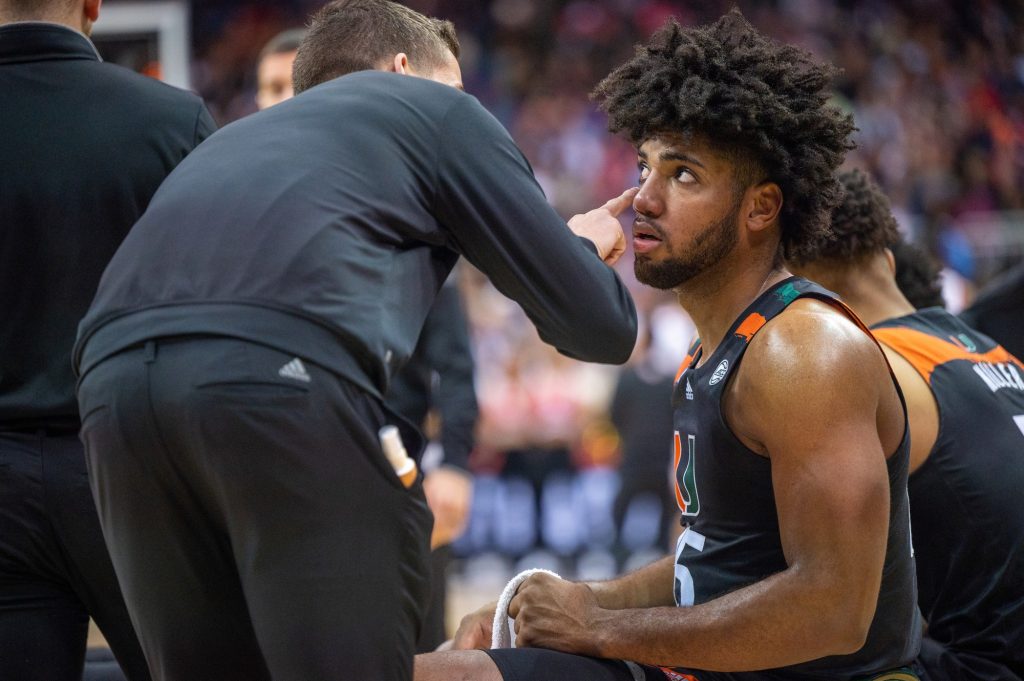 Third-year sophomore forward Norchad Omier has his eye checked out by a trainer during a timeout in during the first half of Miami's Sweet 16 matchup against the Unviersity of Houston on Friday, March 24 at the T-Mobile Arena.