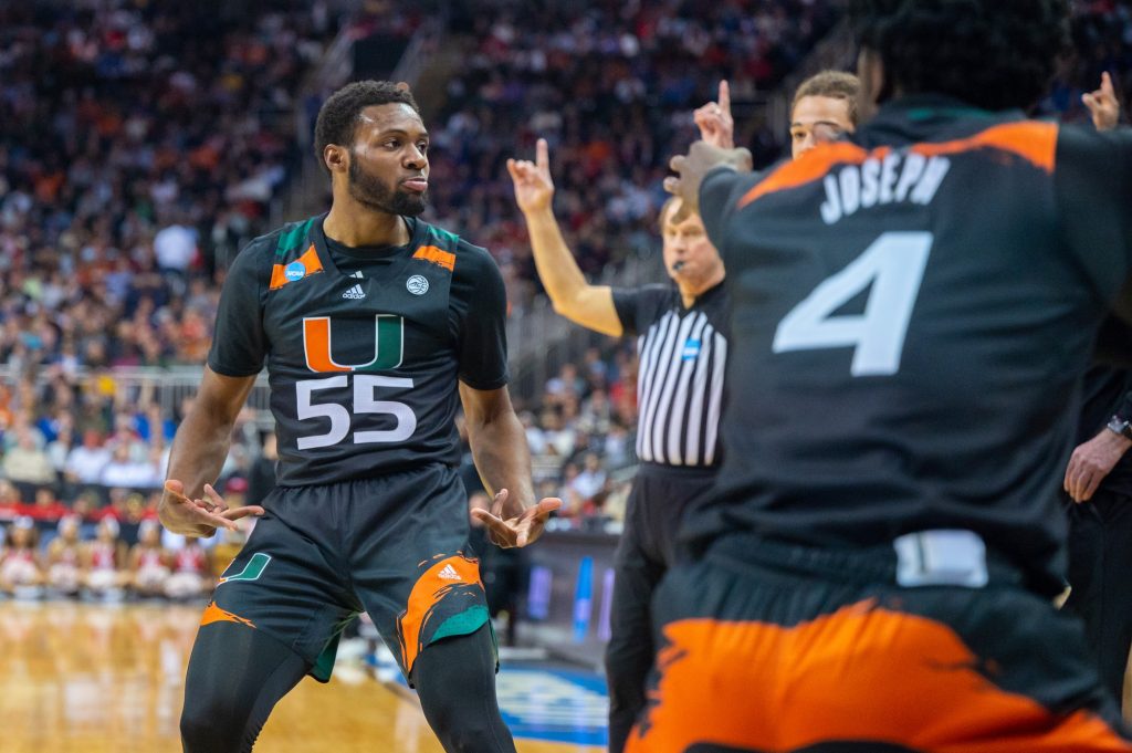 Sophomore guard Wooga Poplar celebrates a three-pointer with the bench during the second half of Miami's Sweet Sixteen win over the University of Houston on Friday, March 24 at the T-mobile Arena.