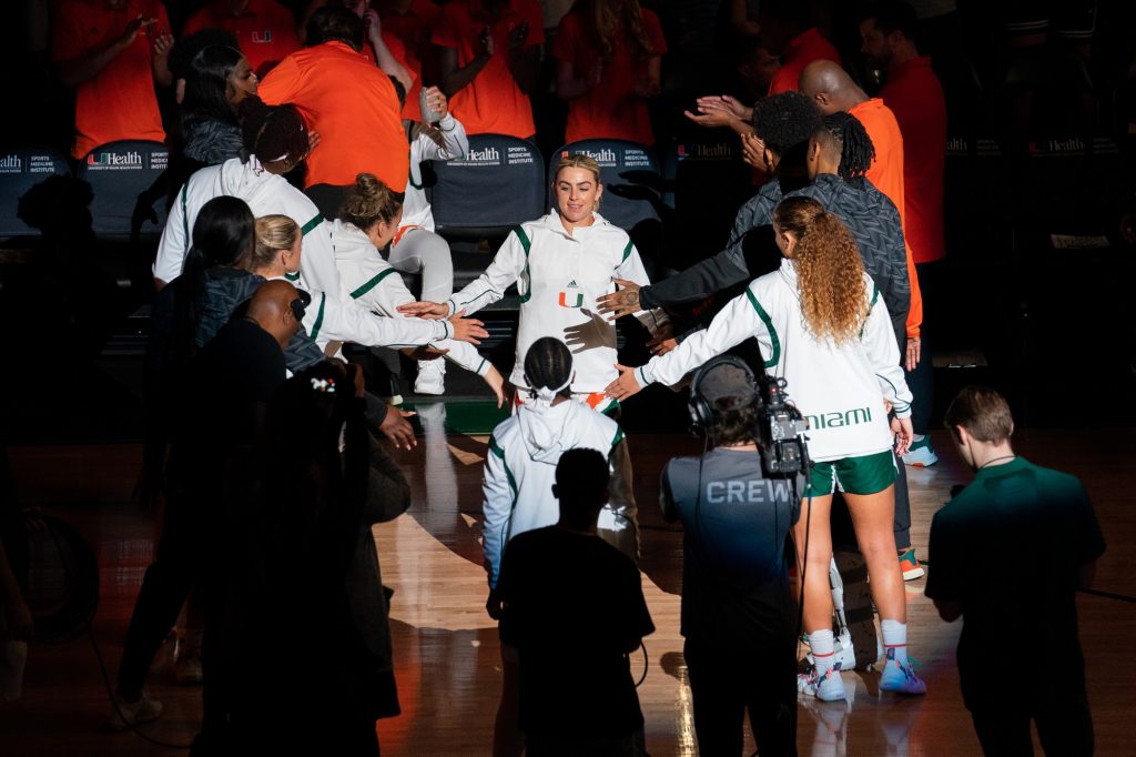 Senior guard Haley Cavinder high fives teammates during player introductions before Miami’s game versus the University of Virginia in the Watsco Center on Feb. 26, 2023.