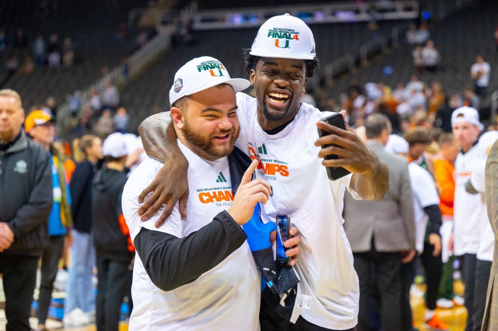 Sophomore guard Bensley Joseph takes a video on his phone with a team manager after beating Texas in the Elite Eight on Sunday, March 26 at the T-Mobile Center.