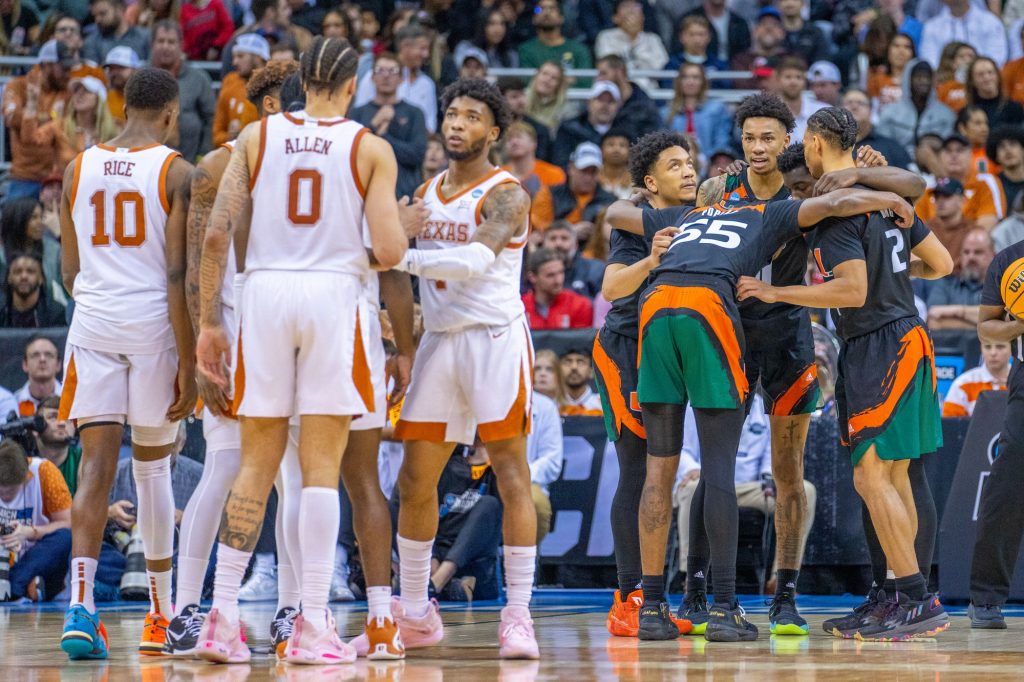 Miami players huddle during the first half of their Elite Eight matchup against the University of Texas in the T-Mobile Center in Kansas City, MO on March 26, 2023.