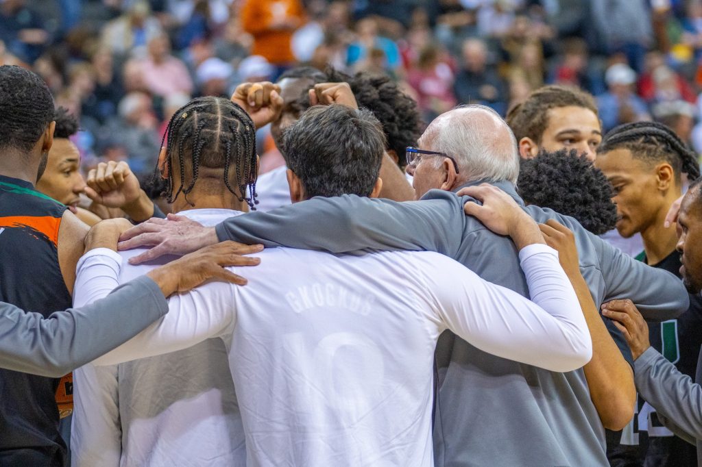 Head coach Jim Larrañaga huddles with his players during a timeout in the second half of Miami’s Elite Eight matchup against the University of Texas in the T-Mobile Center in Kansas City, MO on March 26, 2023.