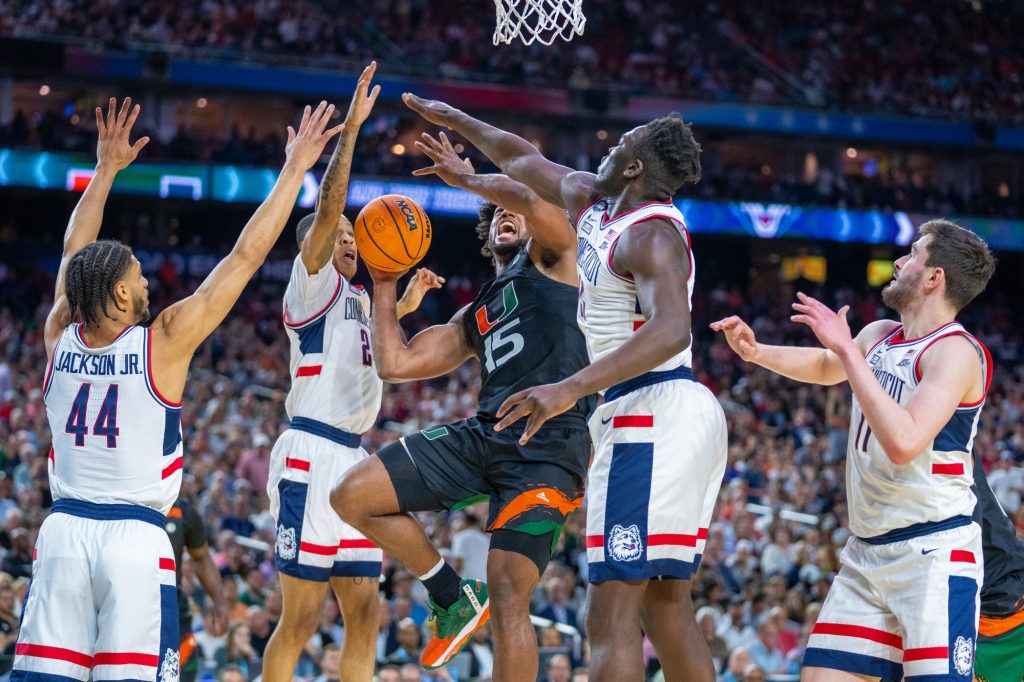 Third-year sophomore forward Norchad Omier fights past defenders during the second half of Miami’s Final Four matchup against the University of Connecticut in NRG Stadium in Houston on April 1, 2023.