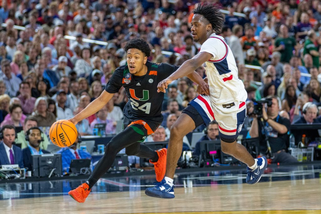 Third-year sophomore guard Nijel Pack drives the ball down court during a fast break during the first half of Miami’s Final Four matchup against the University of Connecticut in NRG Stadium in Houston on April 1, 2023.