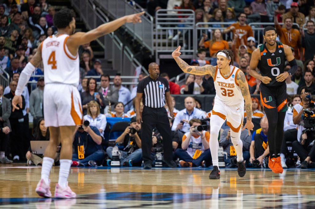 Senior forward Christian Bishop of the University of Texas celebrates a point during the first half of Miami's Elite Eight matchup on Sunday, March 26 at the T-Mobile Center.