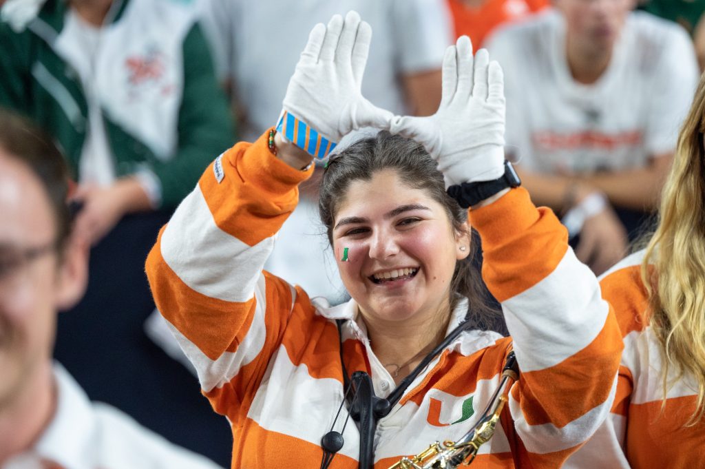 Senior saxophone player Jayme Podgorowiez throws up the U during halftime of Miami's Final Four loss to the University of Connecticut on Saturday, April 1 at the NRG Stadium.