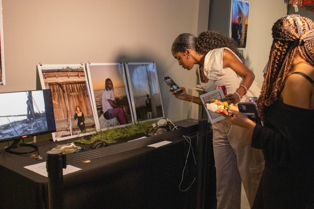 Students appreciate the artwork on display at the VISIONS art exhibit that represents the artist's interpretation of Afrofuturism on Feb. 10 in the Lakeside Pavilion.