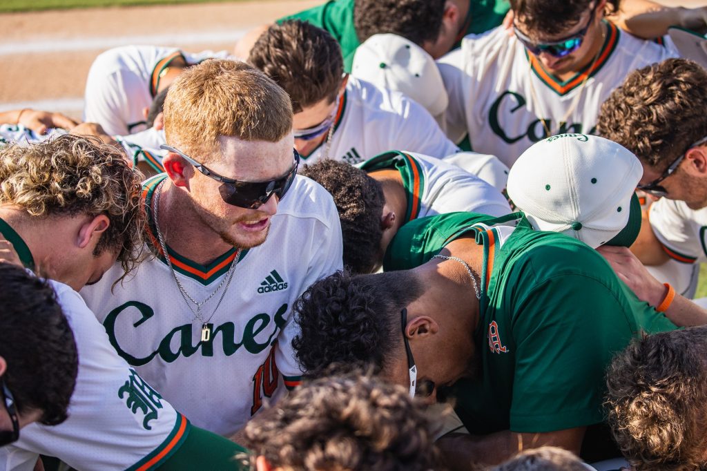 University of Miami players perform their pregame prayer on May 10, 2023 against Florida International University at Alex Rodriguez Park at Mark Light Field.